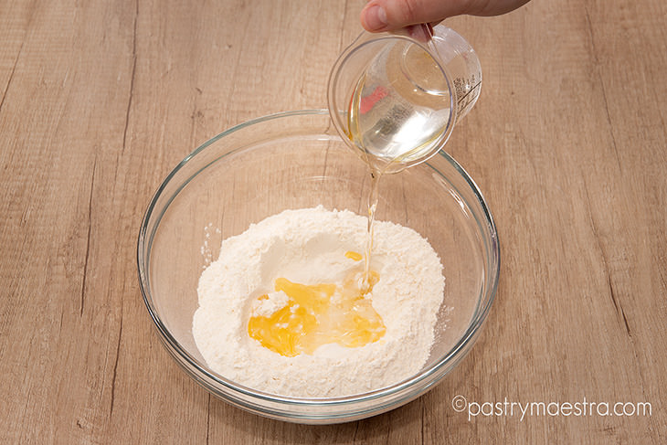 Pouring-liquid-into-dry-ingredients-phyllo-Pastry-Maestra-chef-Tereza-Alabanda